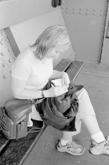 Gina writing postcards in the Eiffel Tower